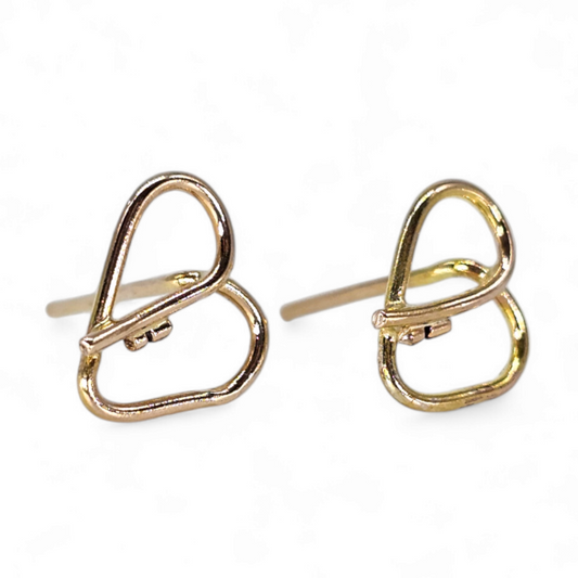 14K Gold heart shaped stud earrings that form a key in the center.