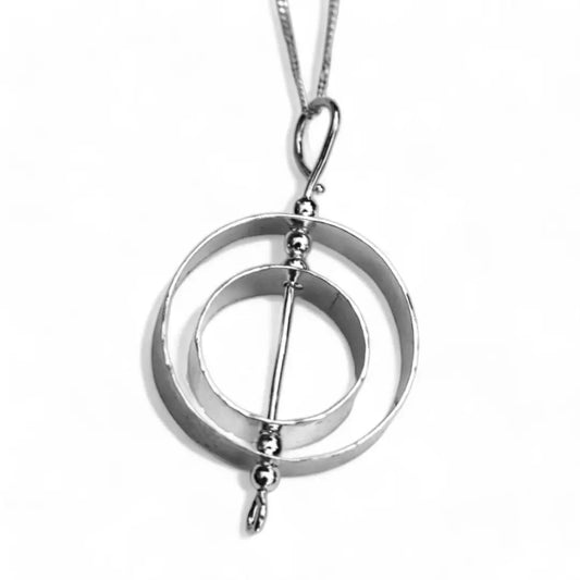 Sterling silver double circle karma necklace that spins to make it a unique piece of fidget jewelry for adults.