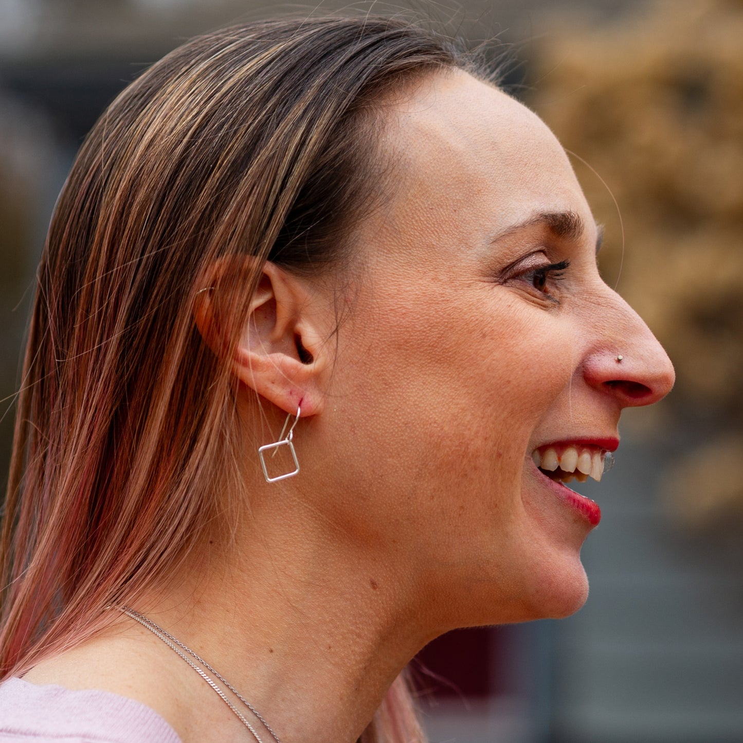Silver Dangle Earrings for Box Breathing worn by smiling woman