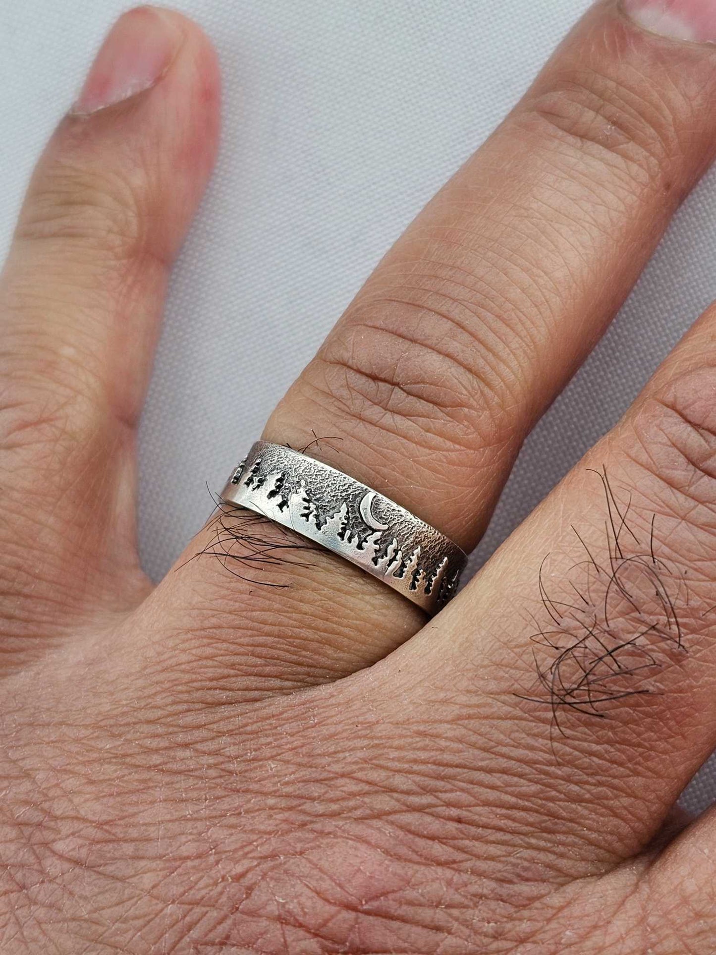 Custom jewelry design ring with moon and trees on man's finger handmade by Jaclyn Nicole