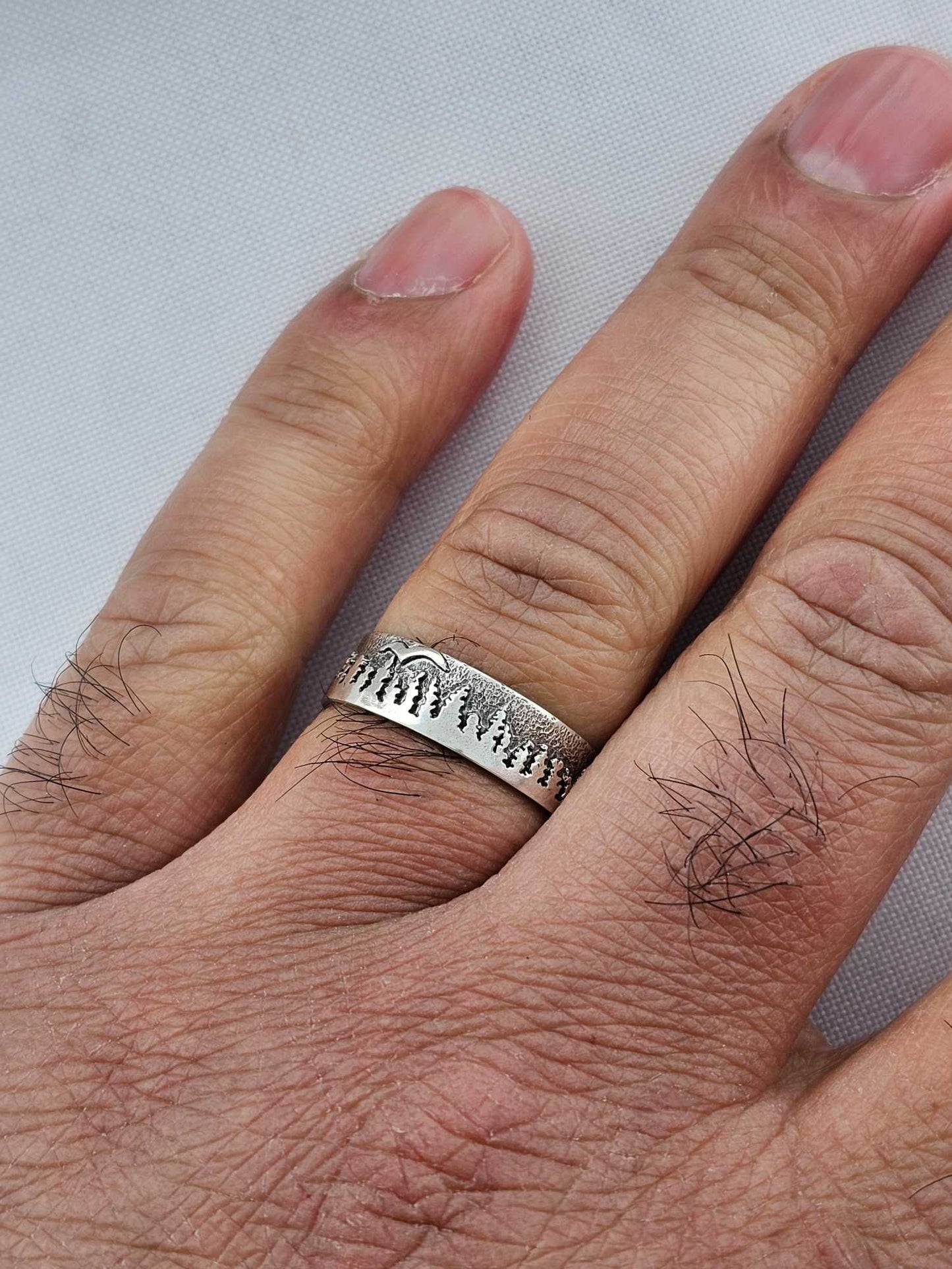 Custom jewelry design ring with trees and bird on man's finger by Jaclyn Nicole