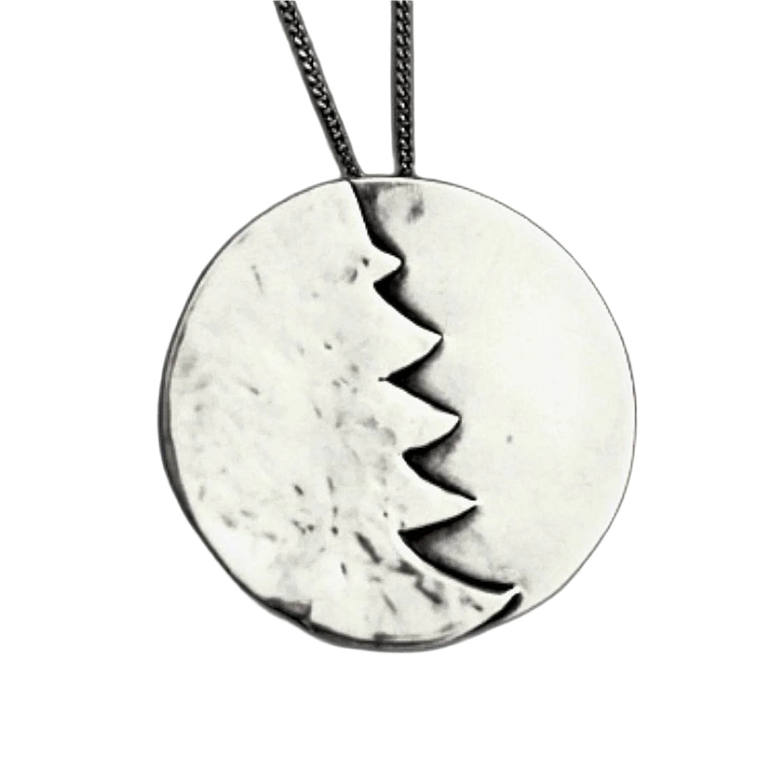A silver Christmas necklace on a white background.