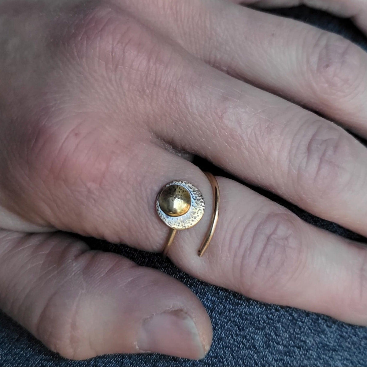 Adjustable 14K Gold Moon Ring for strength modeled on a woman's hand.