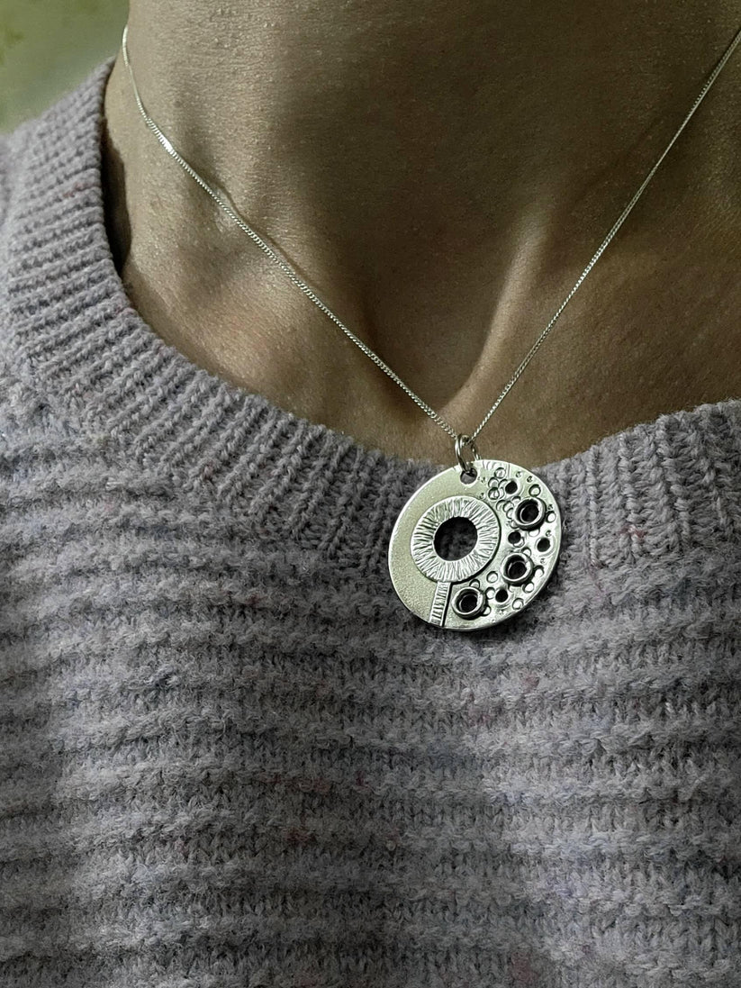 Close-up of one of our Bubble Necklaces promoting benefits of breathwork