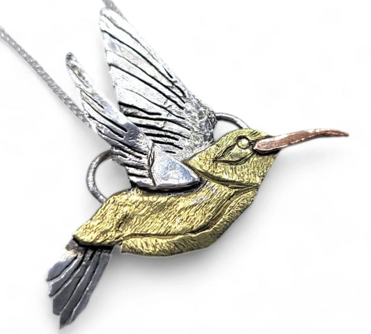 Hummingbird necklace made from Sterling Silver, gold and copper on a white background.