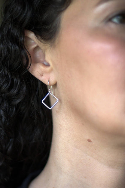 Reminders of the power of breathwork in dainty earrings using the box breathing technique
