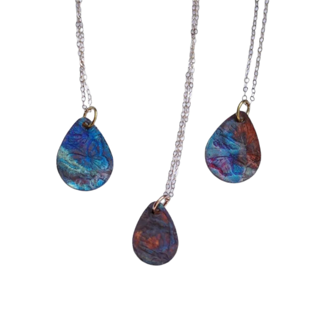 3 Flame Painted Embossed Copper Necklaces on a white background
