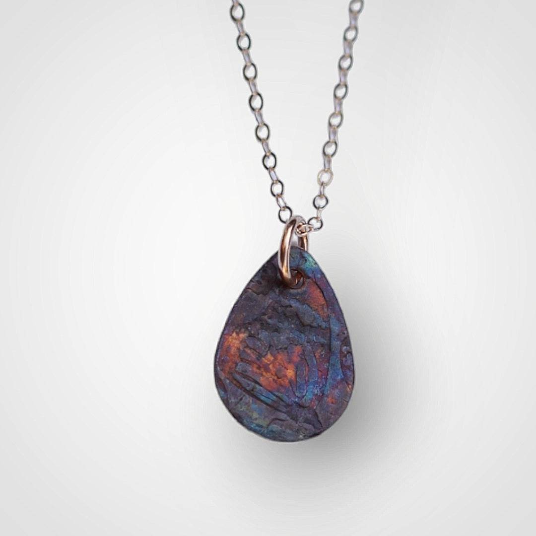 Copper Necklace embossed with a butterfly wing and colored by the flame of a torch.