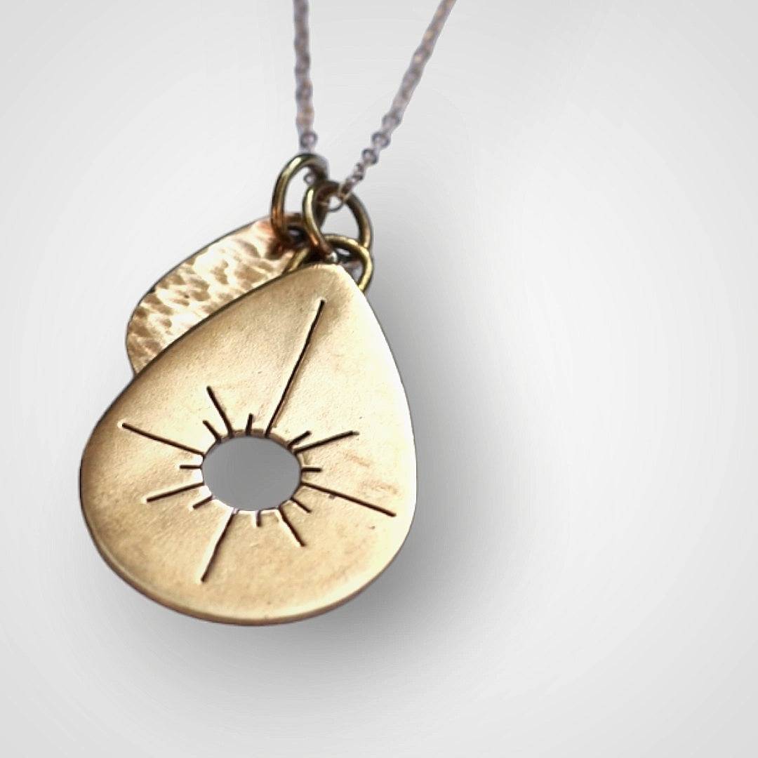 solid brass medium and small drop pendants, hand crafted with texting and sawing.