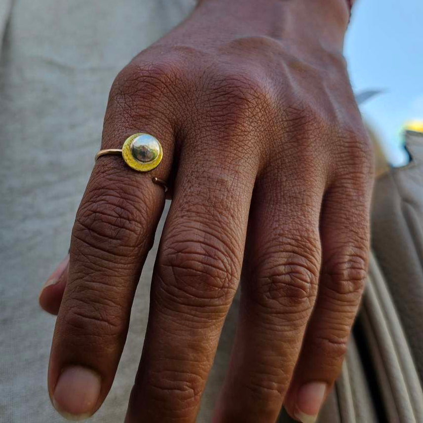 Woman wearing an adjustable gold and silver moon ring.