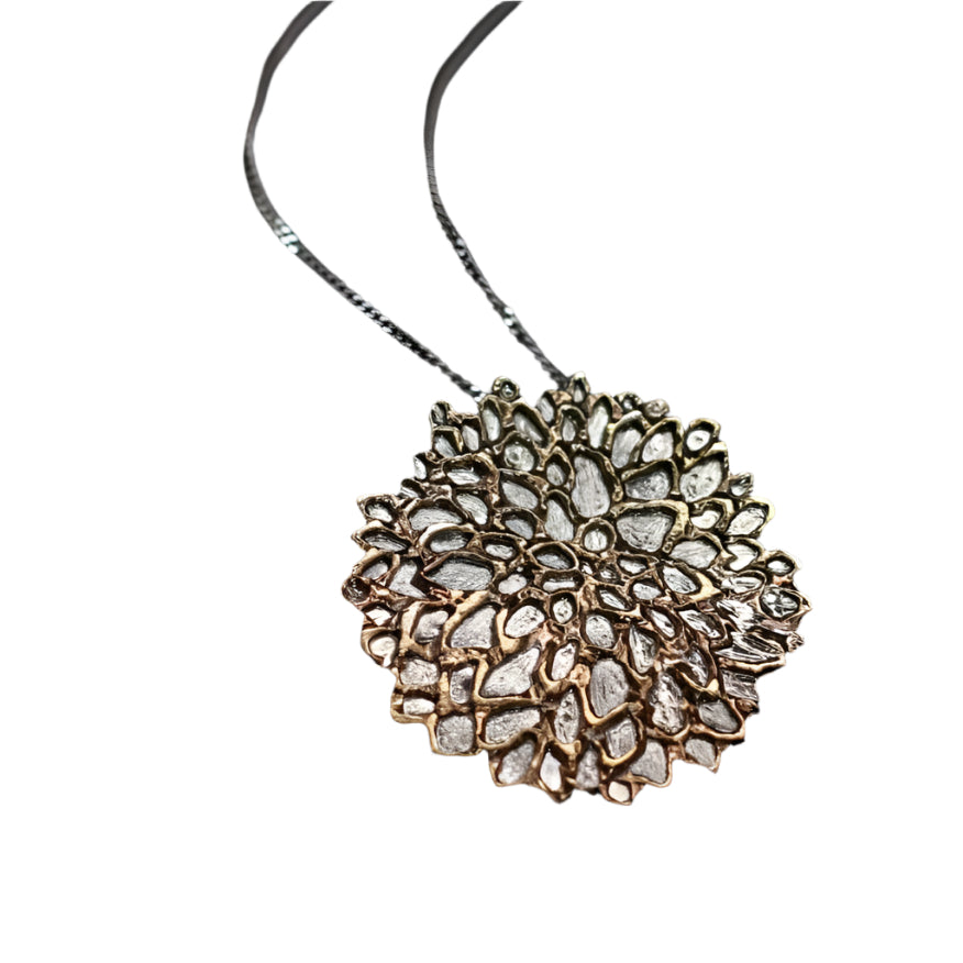 close up of handmade dahlia pendant necklace on black background