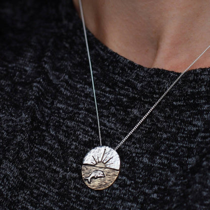 Artisan-Crafted-Dolphin-Necklace-With-Sunset-Backdrop