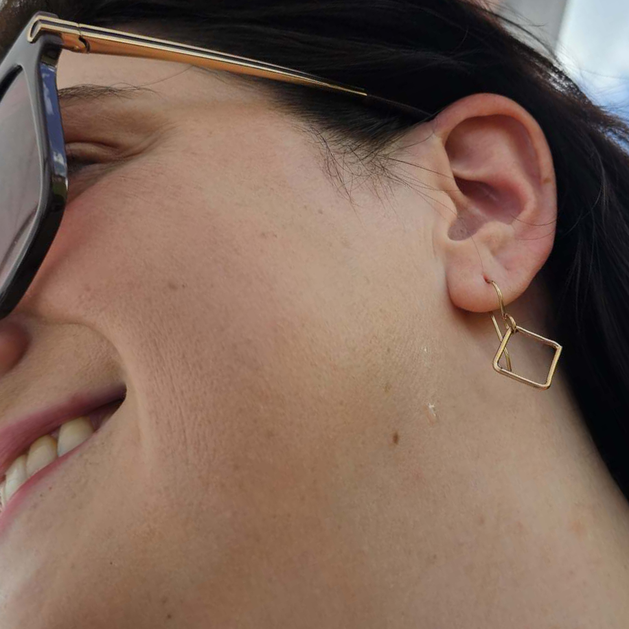 Smiling woman with sunglasses wearing Gold Square Drop Earrings