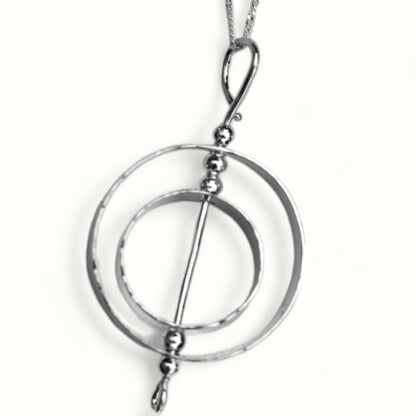 Kinetic karma symbol necklace that spins representing the laws of karma.