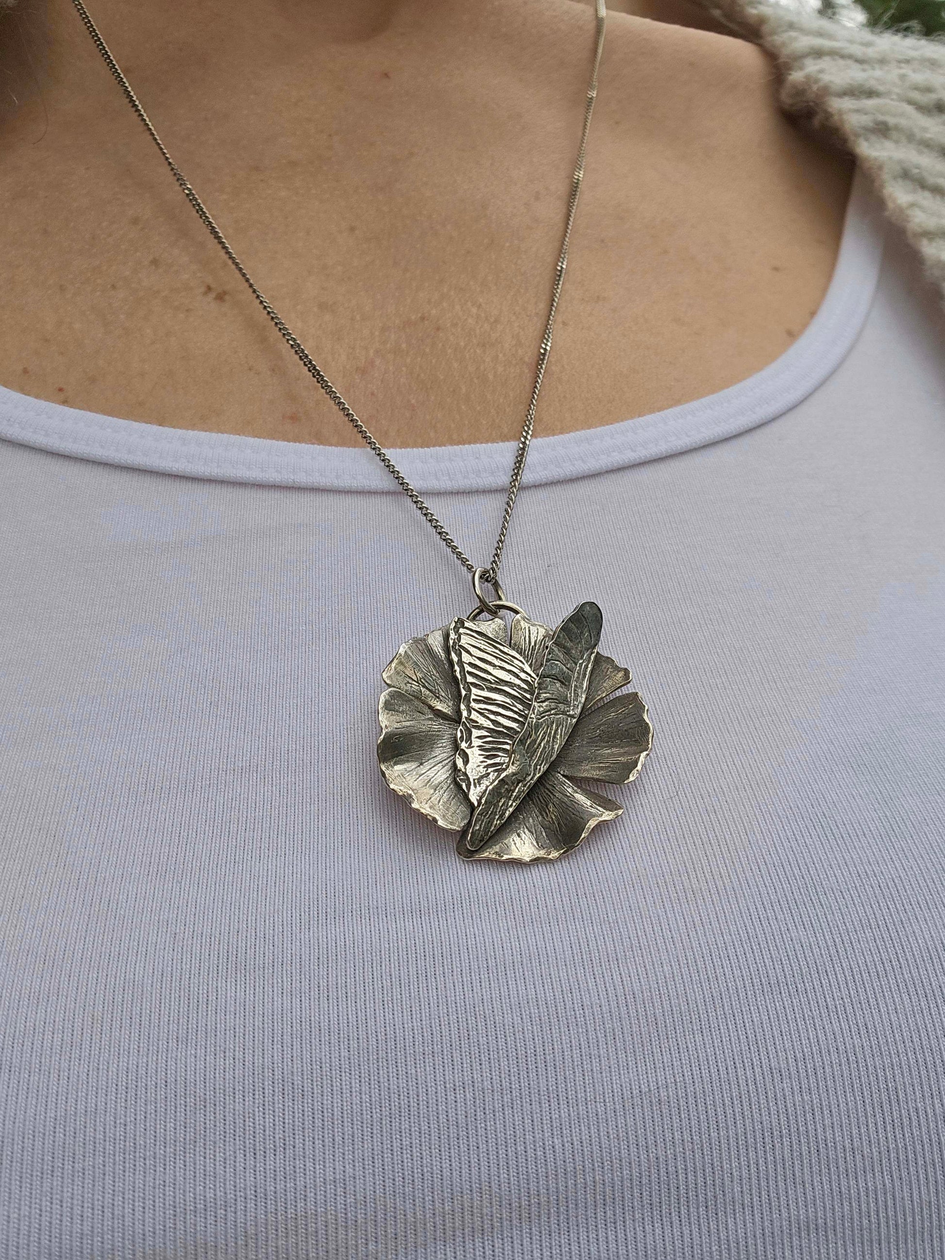 Artisan butterfly necklace with flower in silver