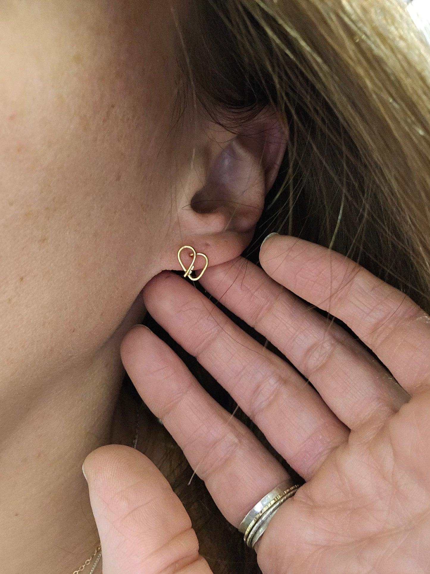 Self love key cute earrings in 14K Gold on a woman's ear 