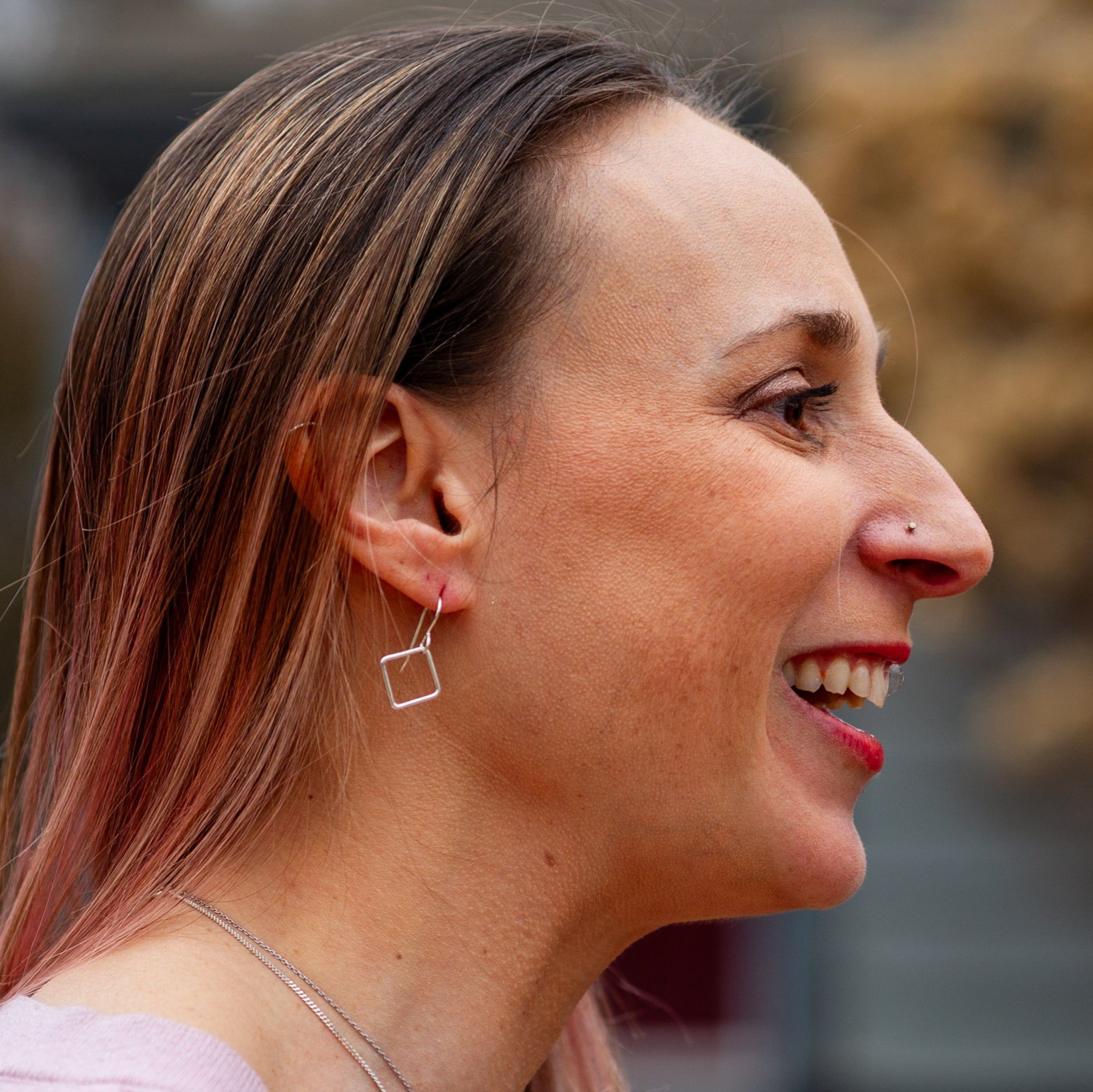 Silver Dangle Earrings for Box Breathing worn by smiling woman