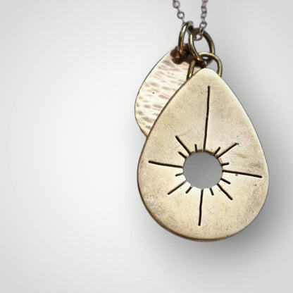 solid brass drop pendants in medium and small with hand crafted sawed sun burst and hammer texturing.