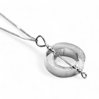 Sterling silver karma necklace representing What Goes Around Comes Around by inspirational jewelry artist Jaclyn Nicole