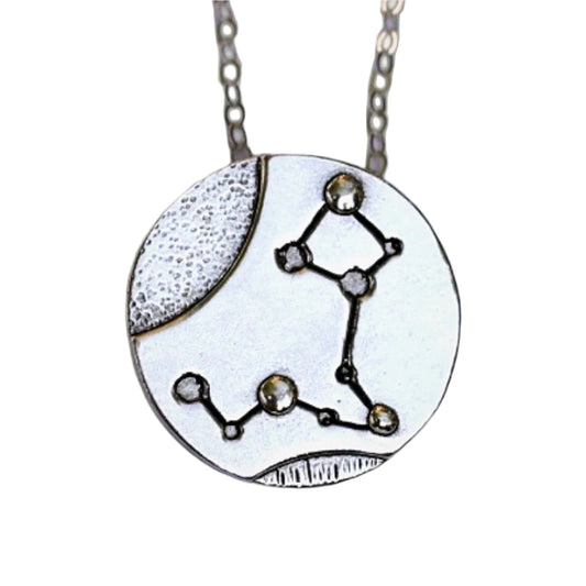 Silver Pisces zodiac necklace close up