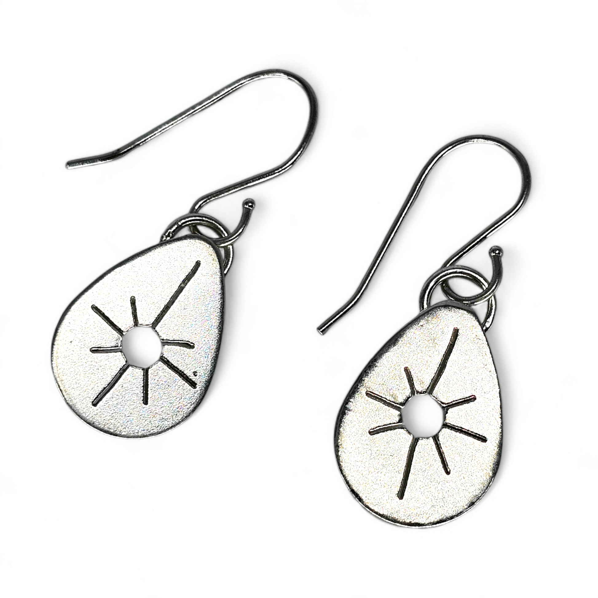 Silver Drop earrings in teardrop shape with Starburst cut out of the center.