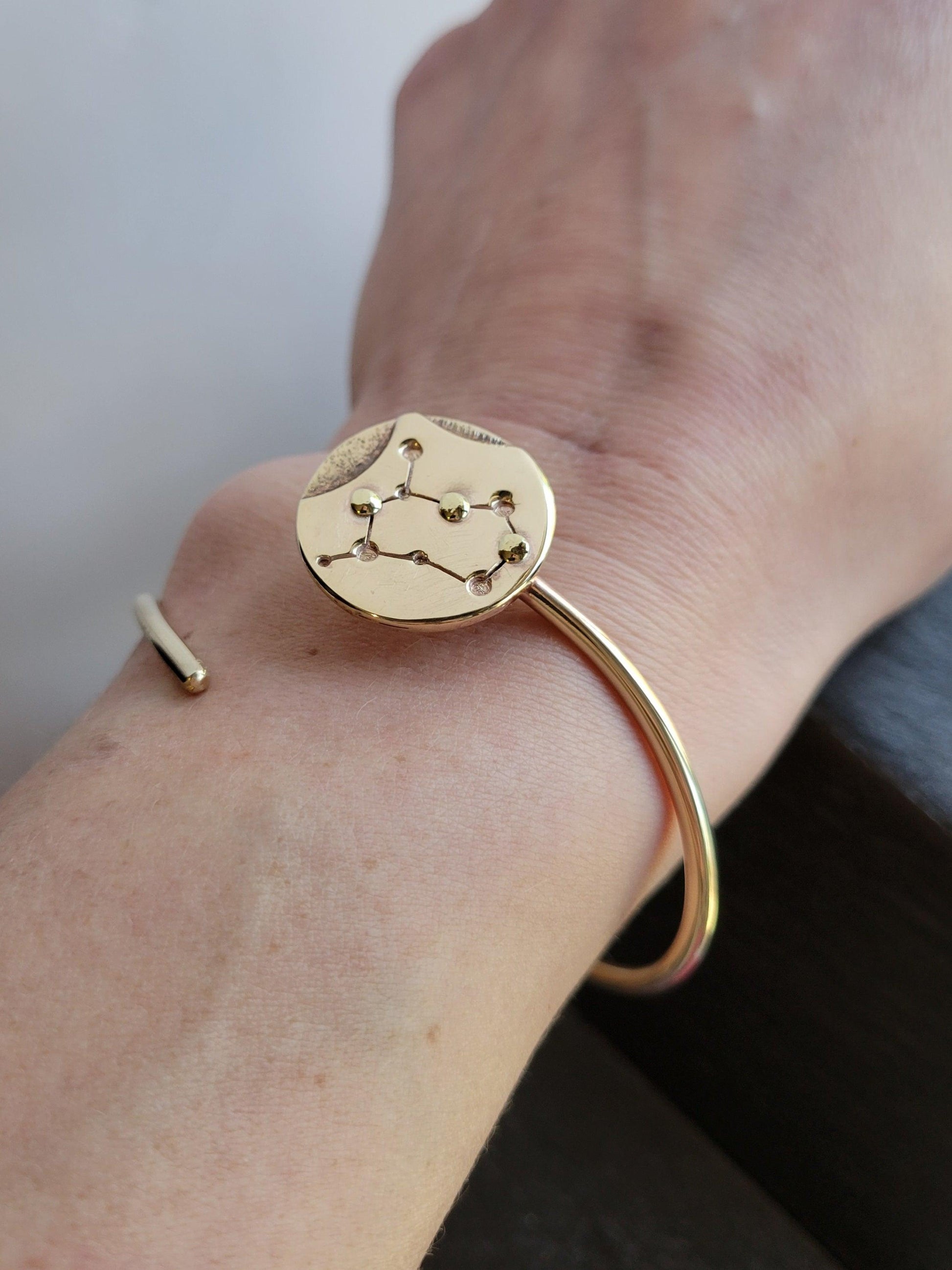 Brass Gemini Zodiac Bracelets on a woman's wrist