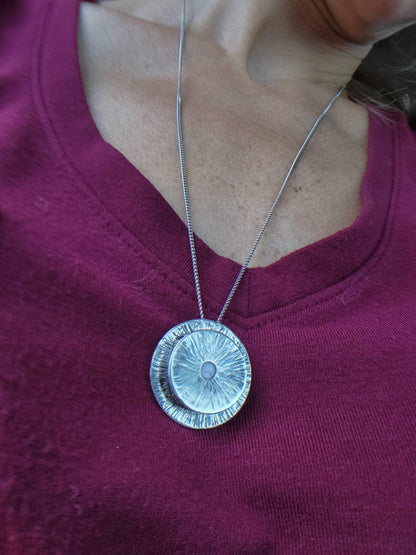 Close-up of the Vessel Manifestation Necklace showing the compartment for intentions - ideal law of attraction accessory