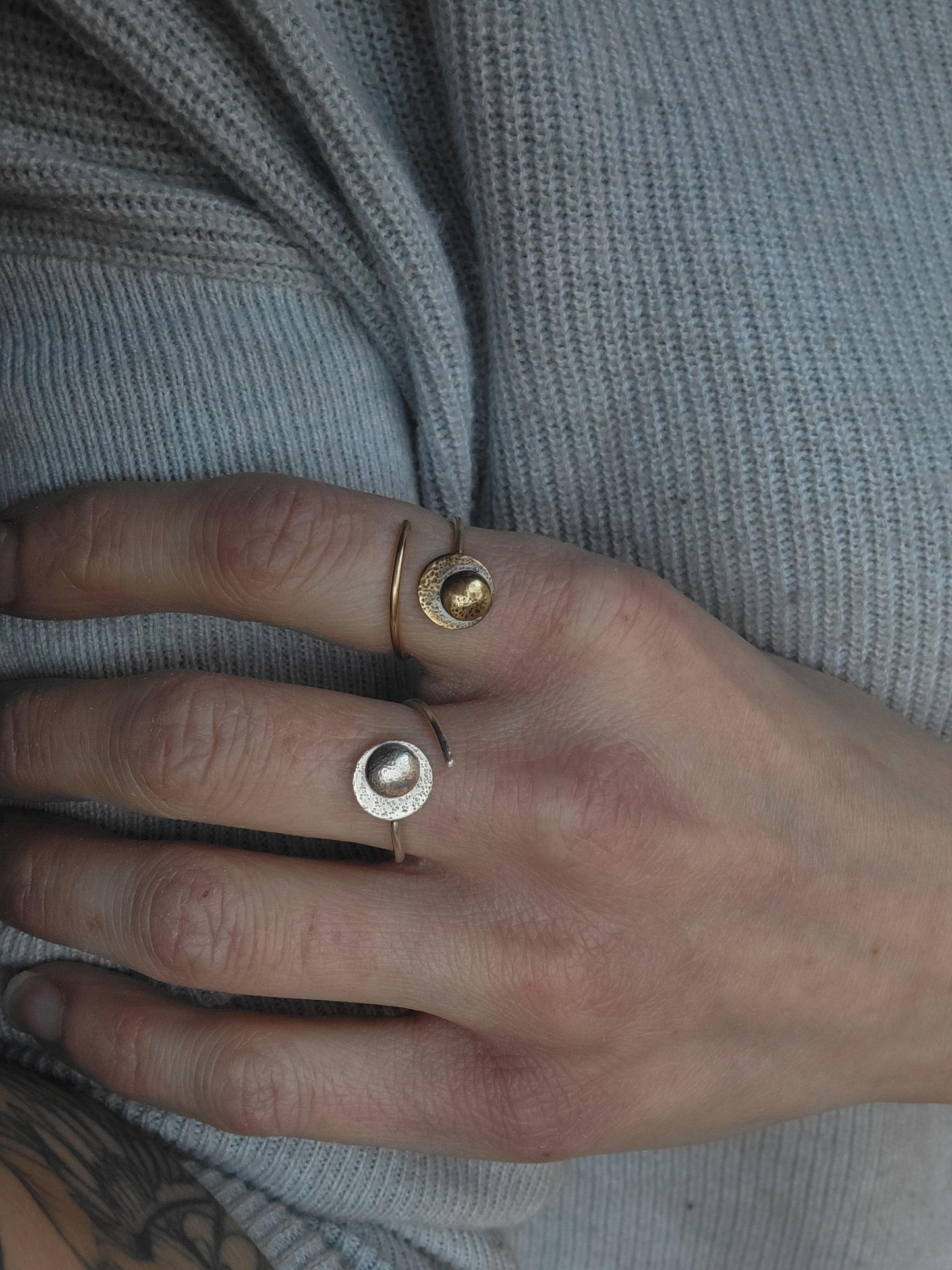 Adjustable Reflections Moon Ring for resilience and strength, shown in gold and sterling silver on a woman's hand.
