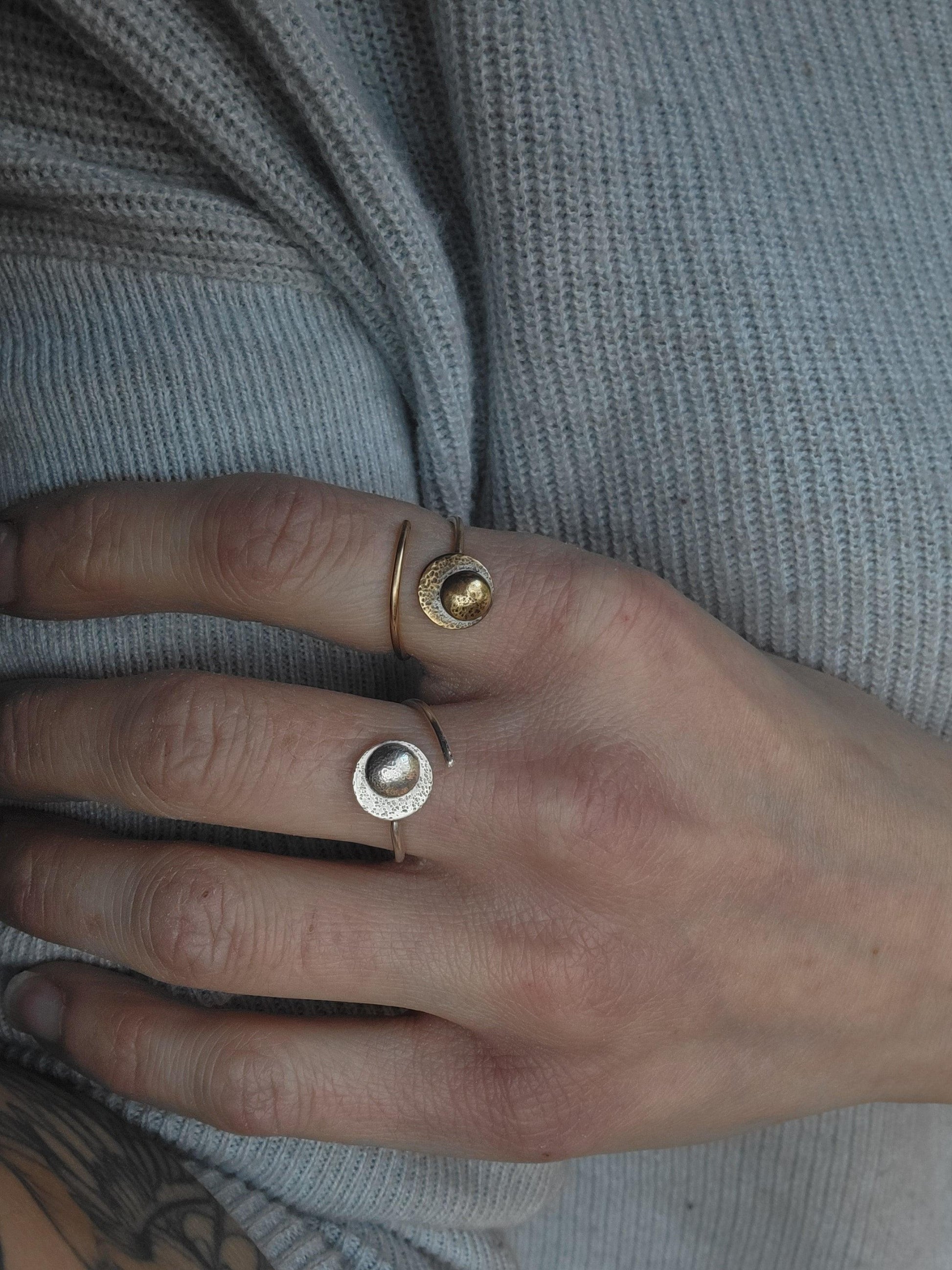 Adjustable Reflections Moon Ring for resilience and strength, shown in gold and sterling silver on a woman's hand.