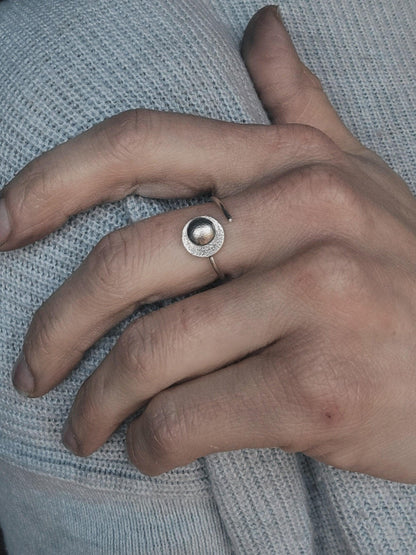 Silver Moon ring that reminds you to reflect on your prior successes to overcome present challenges, modeled on a woman's hand.