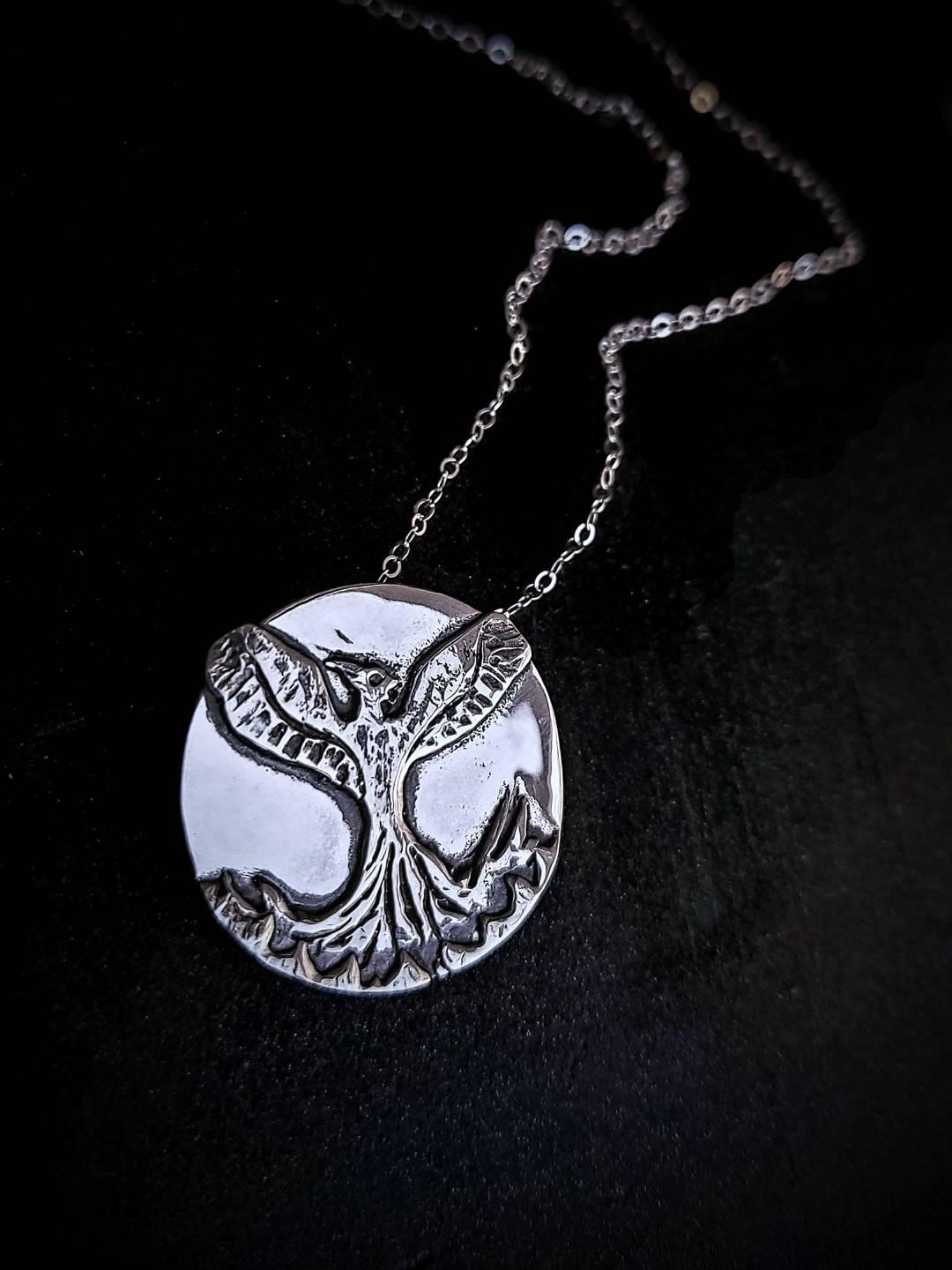 Phoenix necklace representing resilience and rebirth