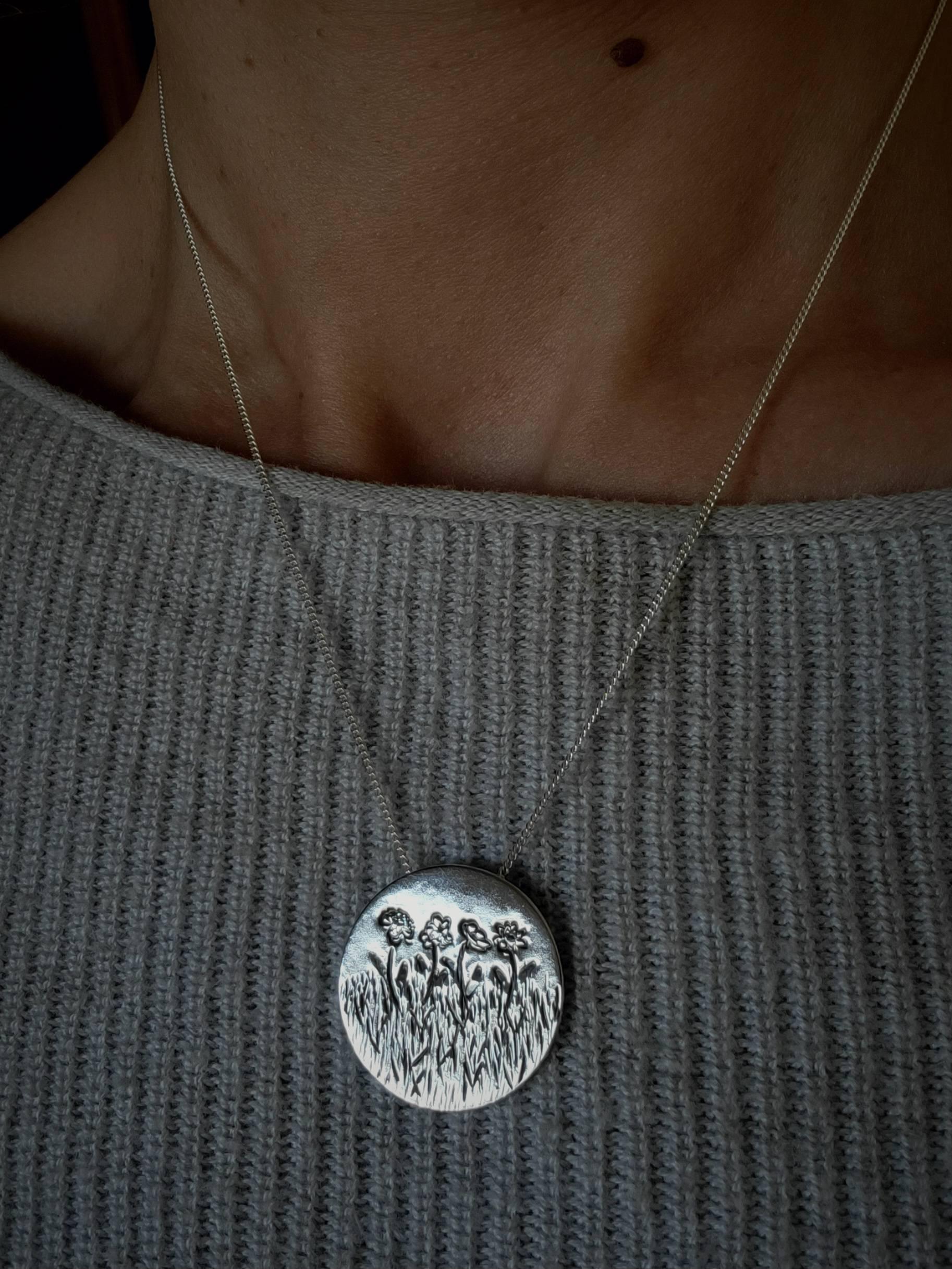 Our birth flower necklaces are a unique personalized necklace for mom, modeled here on a woman's neck.