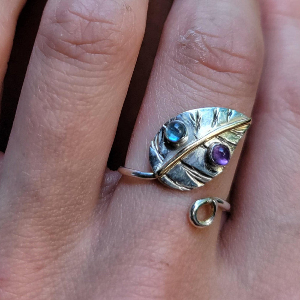 handmade custom jewelry leaf ring set with aquamarine and amethyst stones on woman's index finger
