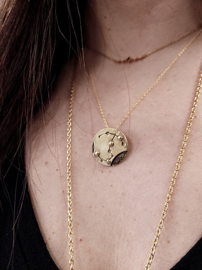 Brass Scorpio necklace worn around woman's neck